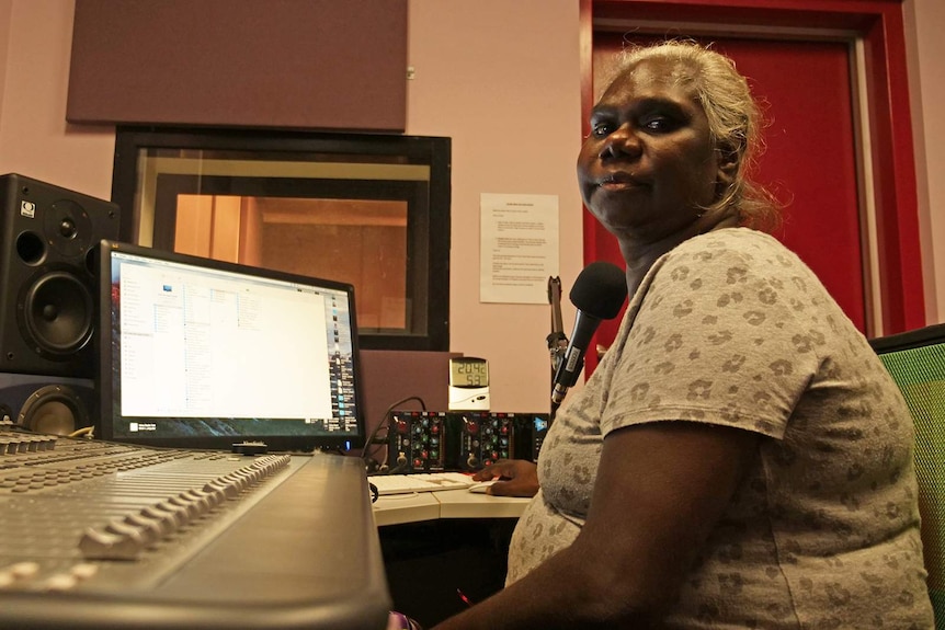 A photo of broadcaster Sylvia Nulpinditj sitting at a radio desk.