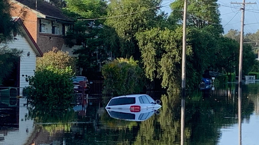a submerged in floodwaters on a suburban street