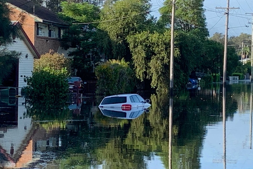 a submerged in floodwaters on a suburban street
