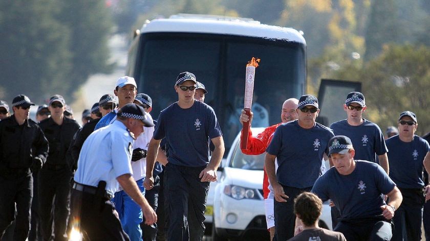 One man was arrested after he sat down in front of torch bearer Robert De Castella.