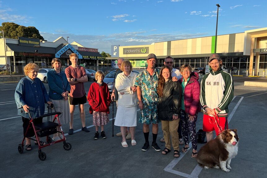 Residents impacted by a gas leak gather at a shopping centre.