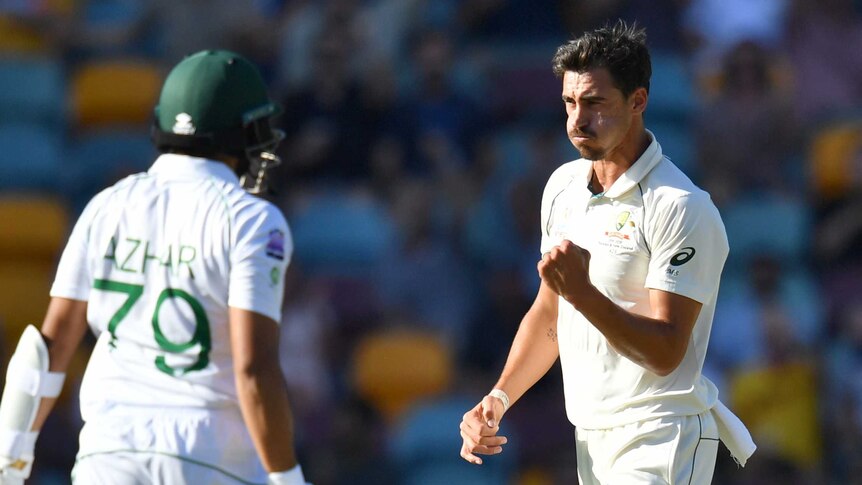 Australia bowler Mitchell Starc pumps his fist as Azhar Ali leaves the field of play during a Test.