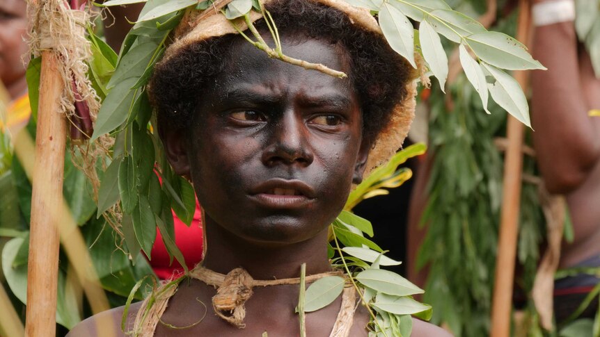 A Manus Island boy in traditional dress to welcome former ABC correspondent Sean Dorney, 2018.