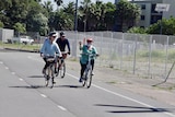 Three people riding their bikes in Newcastle.