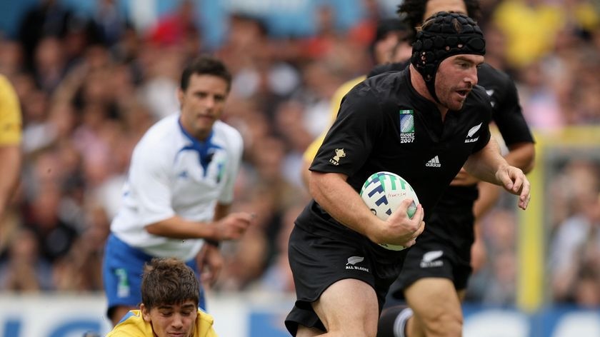 New Zealand All Blacks hooker Andrew Hore breaks away from a Romanian tackle