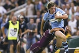 New South Wales winger Luke Rooney attempts to get past the Queensland defence