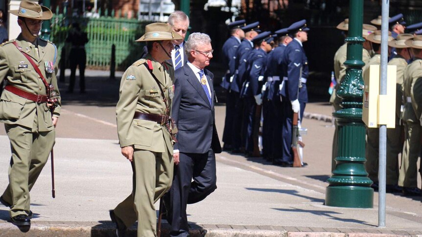 Queensland Governor Paul de Jersey is escorted into State Parliament for the official opening