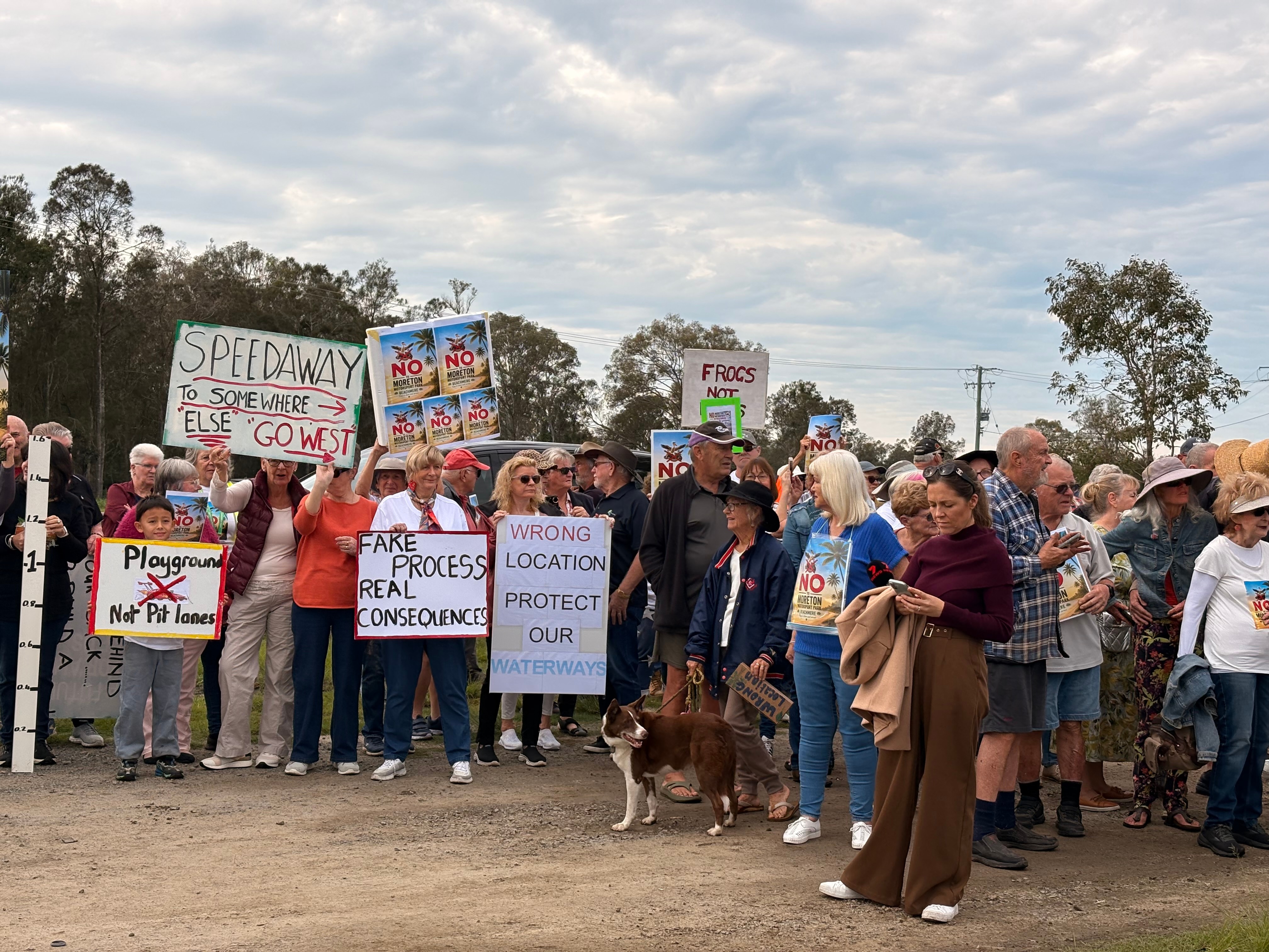 Protesters stand behind a banner at Beachmere.