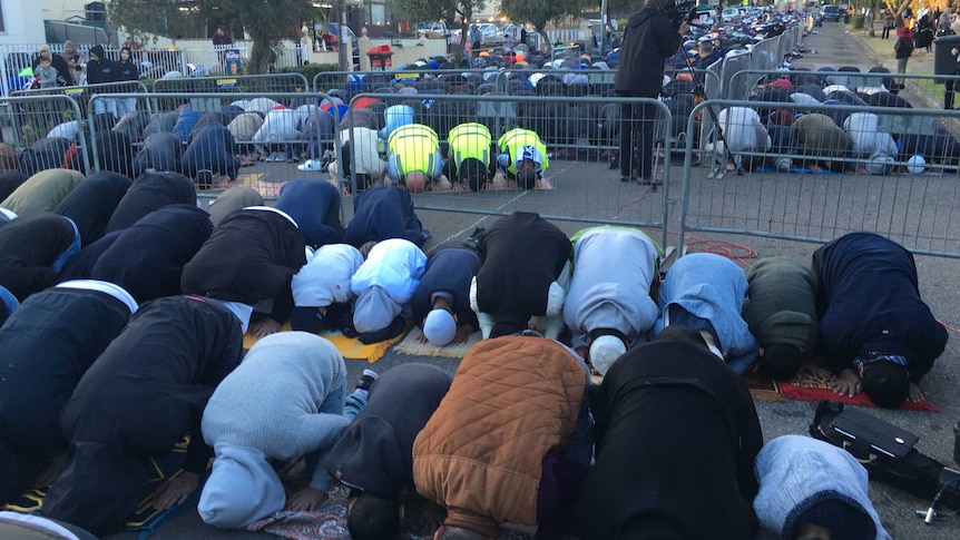 Crowds praying in front of the Lakemba Mosque this morning.