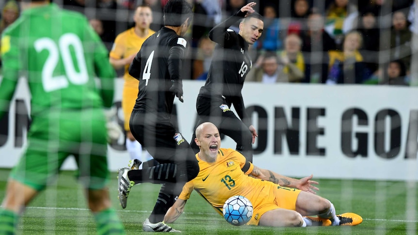 Socceroos' Aaron Mooy tackled against Thailand