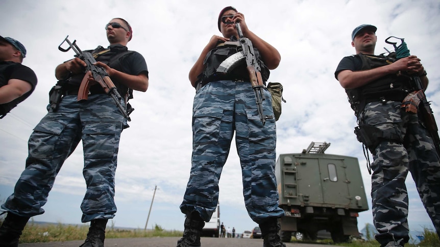 Pro-Russian rebels guard MH17 crash site
