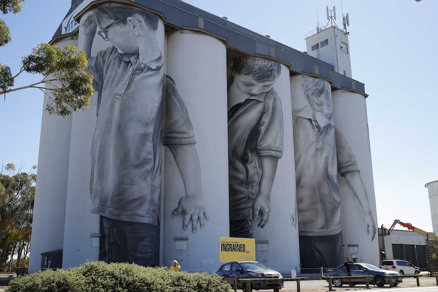Paintings of children on silos