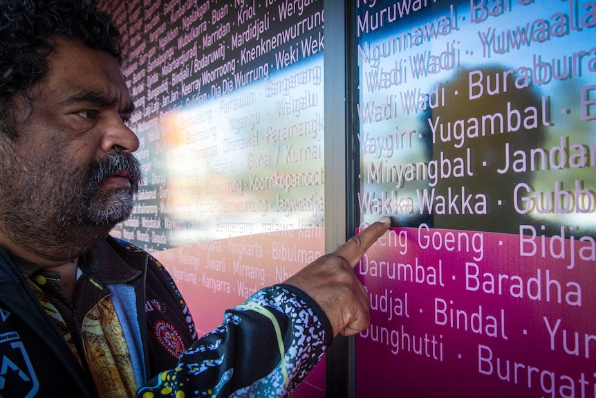 Man points at language group on a sign