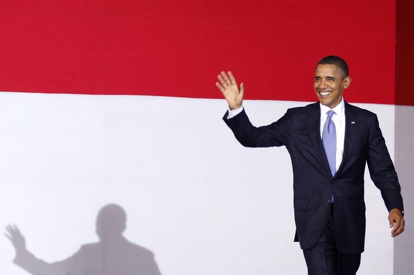 Barack Obama waves as he arrives on stage at the University of Indonesia.