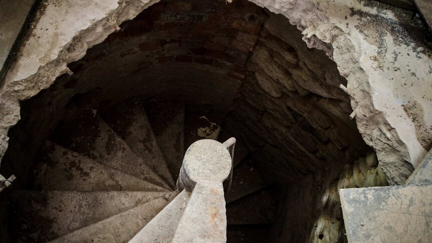 A narrow spiral staircase going underground