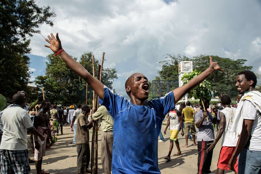 A man celebrates in Burundi after the announcement of a coup