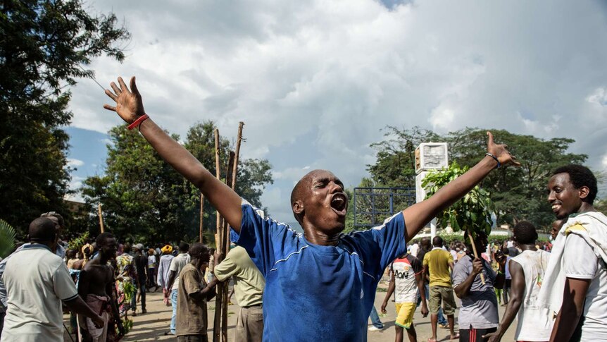 A man celebrates in Burundi after the announcement of a coup