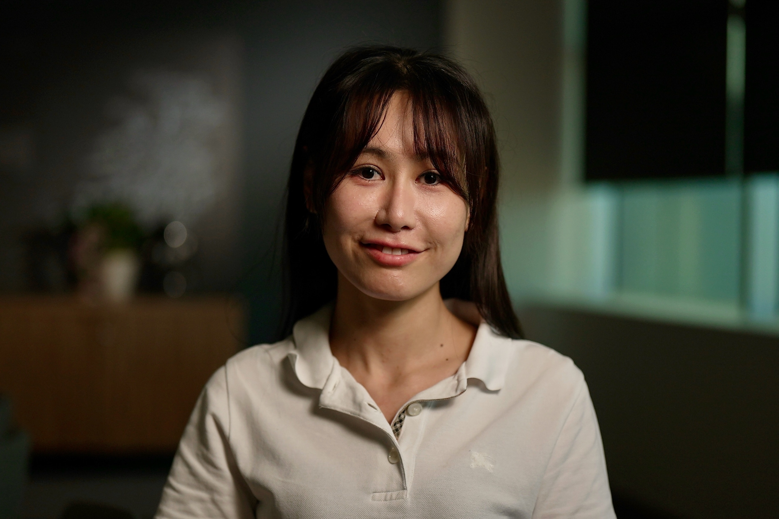 close up image of a woman with dark hair smiling at the camera