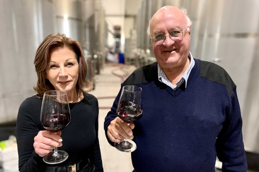 Bill and Vicki Widen holding glasses with red wine