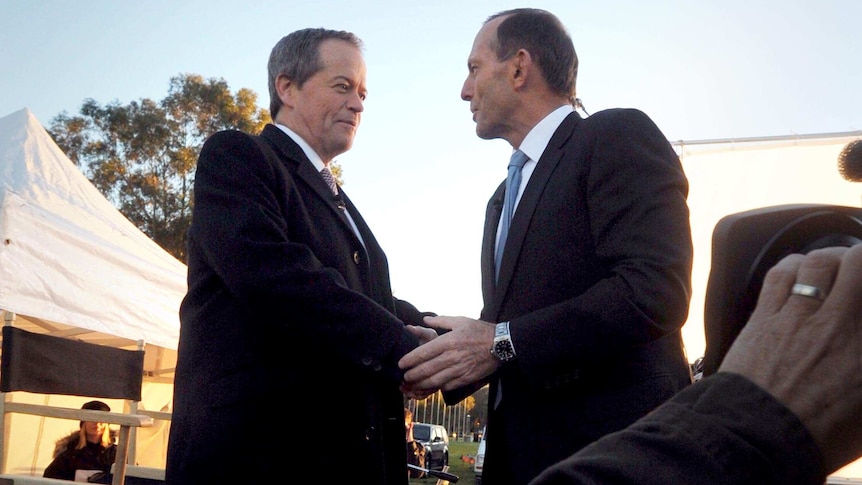 LtoR Opposition Leader Bill Shorten shakes hands with Prime Minister Tony Abbott between interviews.