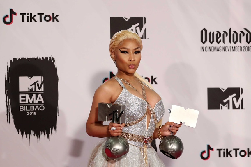 Nicki Minaj poses with her MTV trophies during the 2018 MTV Europe Music Awards.