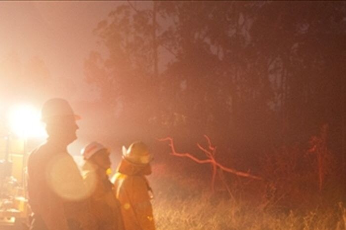 Fire fighters work into the night backburning at Millstream, near Ravenshoe