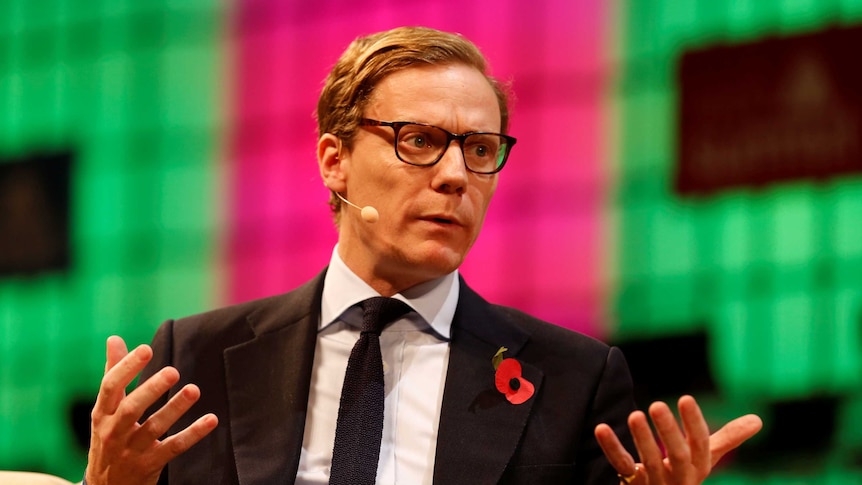 CEO of Cambridge Analytica Alexander Nix sits on a couch and talks during the Web Summit.