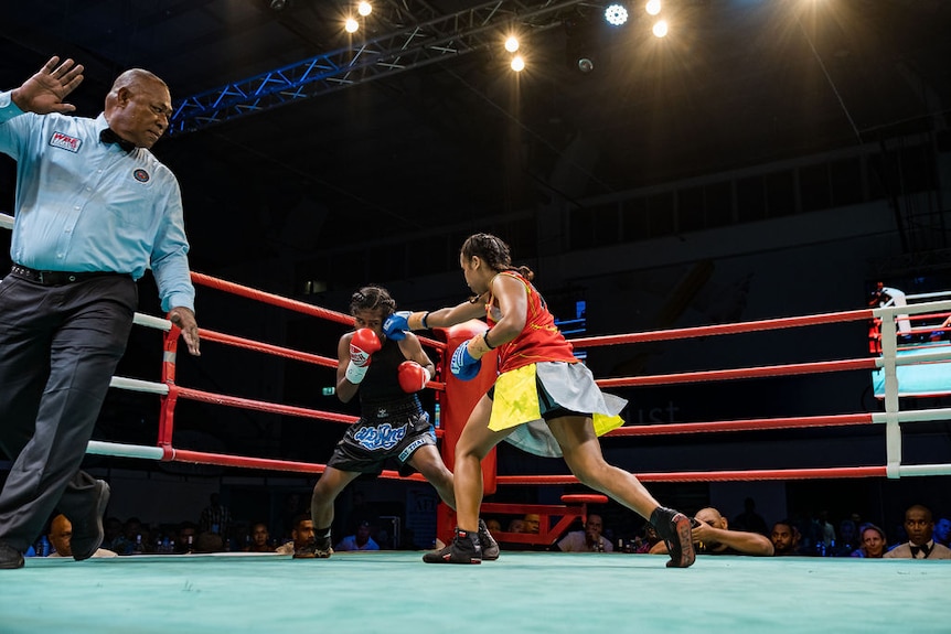 Jasmine Daunakamakama and Mere Kolitapa fight in a boxing bout in Fiji.