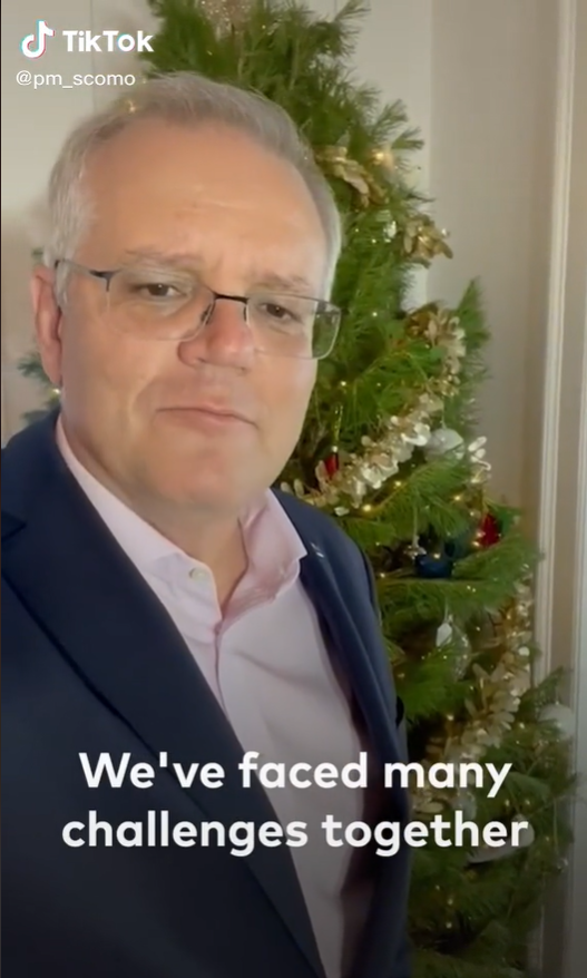 Photo shows Scott Morrison smiling in front of a christmas tree 