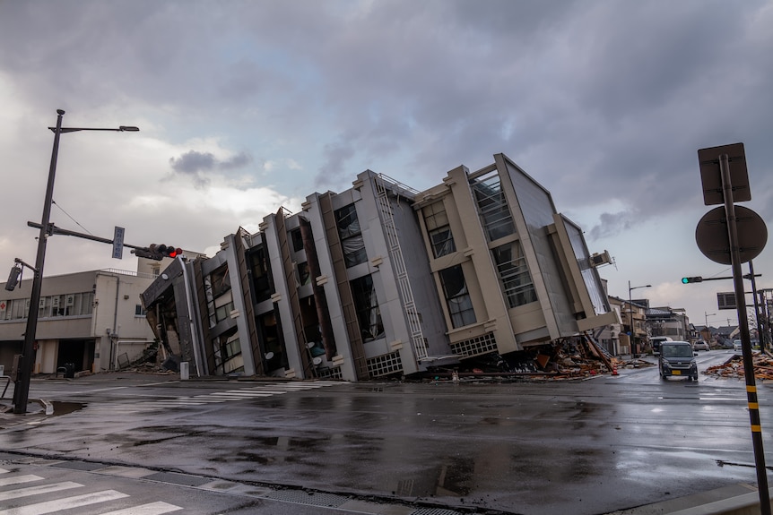 Image of a multiple storey building having collapsed to its side.