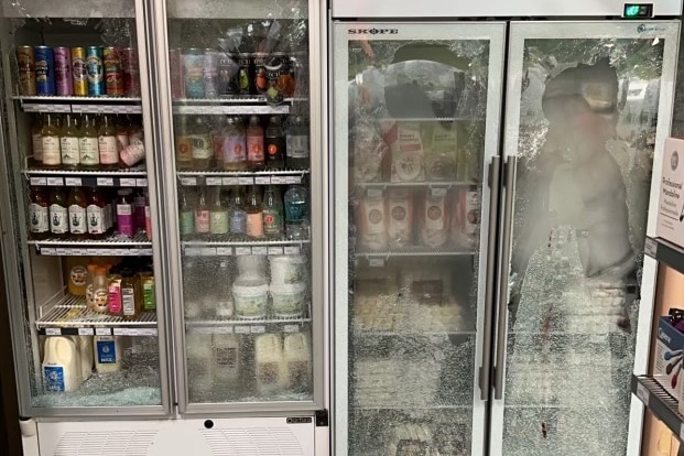 smashed commercial fridges with food inside.