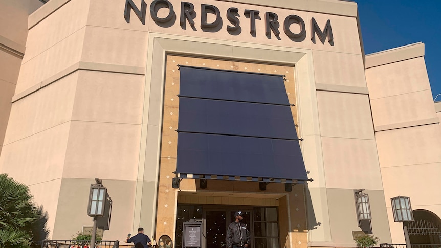 A security guard stands outside the Nordstrom store at The Grove retail and entertainment complex in Los Angeles