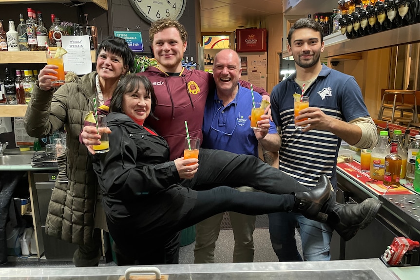 People with drinks at a hotel bar.