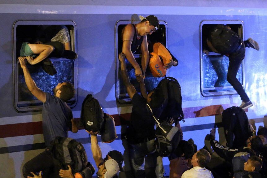 Asylum seekers struggle to board train in Croatia