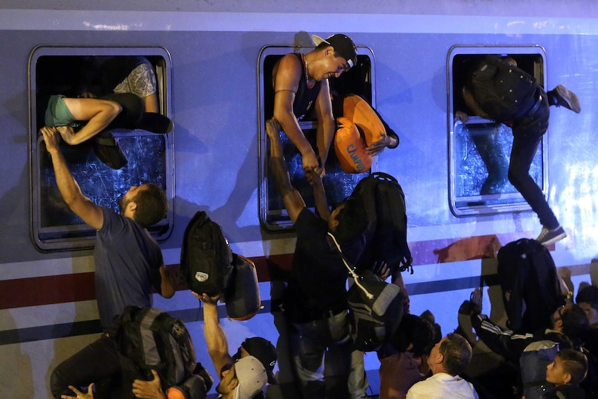 Asylum seekers struggle to board train in Croatia