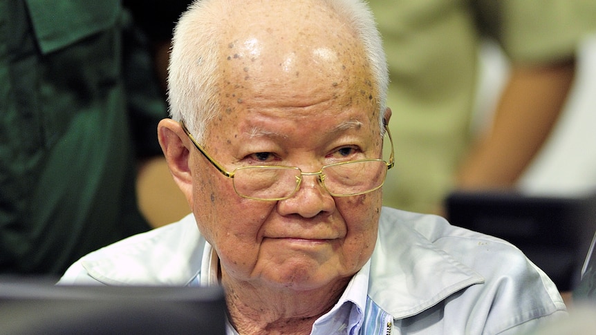 An edlerly Khieu Samphan wearing glasses with thin white hair