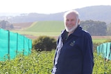 Flower grower Peter Botting stands in his field of peony plants in Forth, Tasmania.