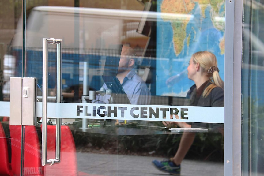 Two employees sit at their desks inside the Flight Centre store at South Bank in Brisbane.