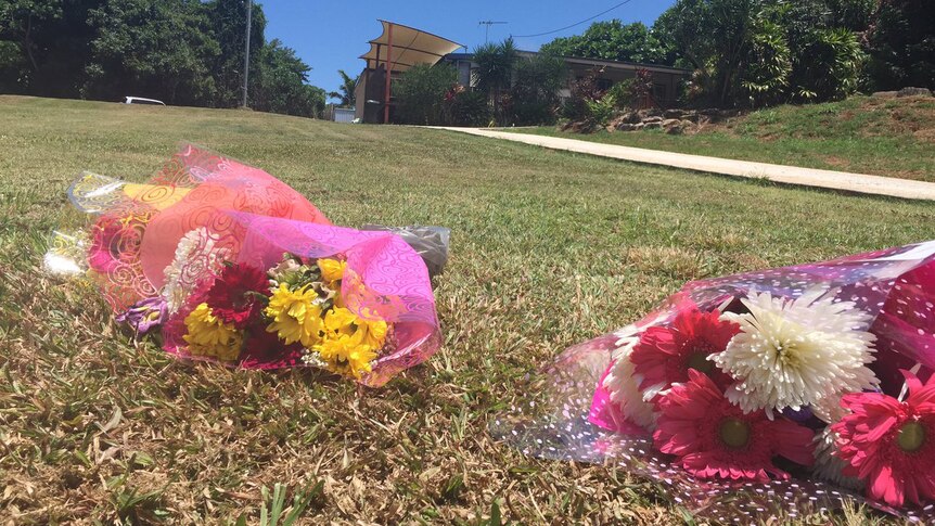 Bunches of flowers at the scene of the skydiving accident at Mission Beach where one of the skydivers was found.