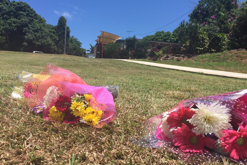 Bunches of flowers at the scene of the skydiving accident at Mission Beach where one of the skydivers was found.