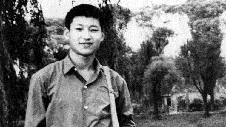A black and white photo of Xi Jinping as a young man.