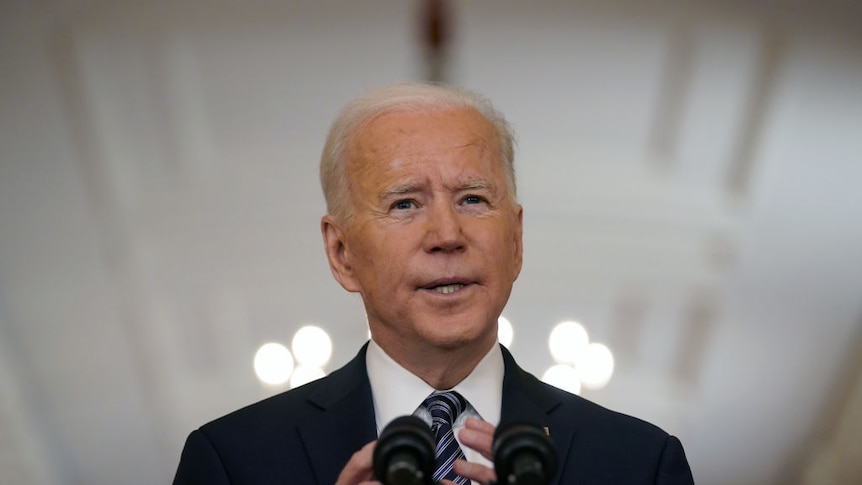 President Joe Biden speaks from a lecturn