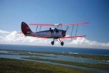 A Tiger Moth Joy Ride plane flies over Stradbroke Island near Brisbane in Queensland.