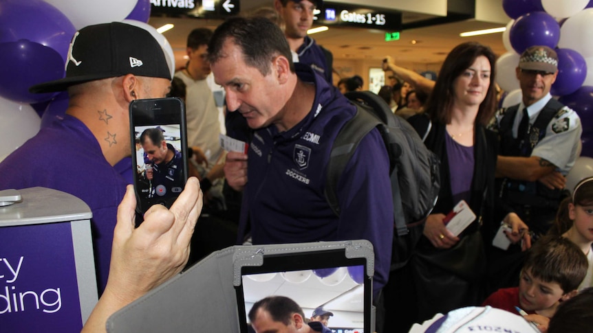 Ross Lyon is mobbed by fans at Perth Airport