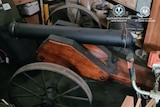 An old style cannon with wooden frame