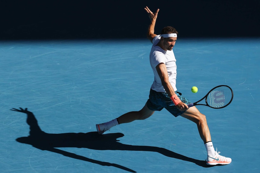 Grigor Dimitrov plays a backhand at the Australian Open.