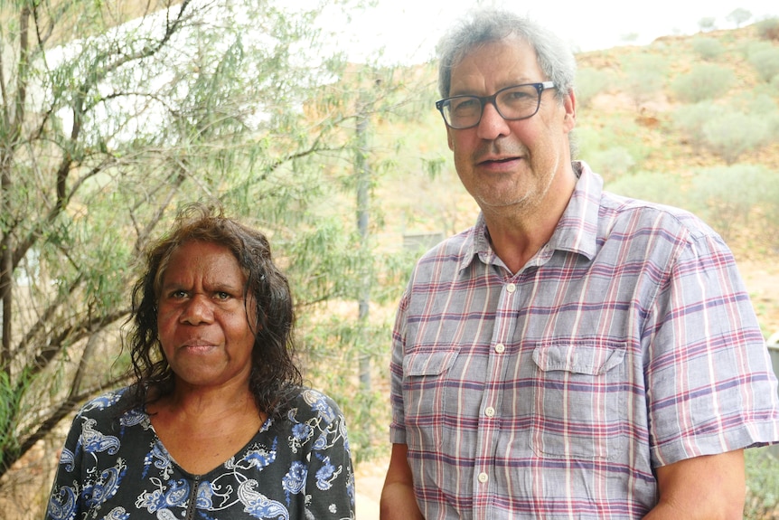 An Aboriginal woman and a white man wearing glasses