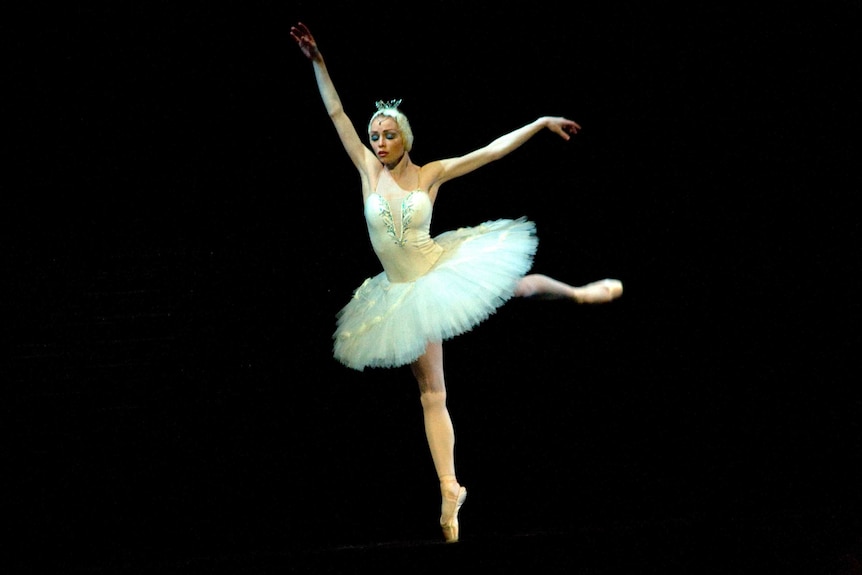 The Prima Ballerina playing the Swan Princess Odette during a solo in Tchaikovsky's 'Swan Lake'.