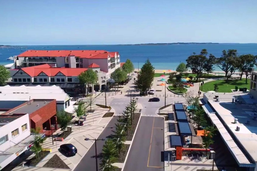 An aerial shot of a town centre foreshore looking out towards the beach