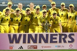 Australia celebrates with the trophy after defeating India in it ODI matches.